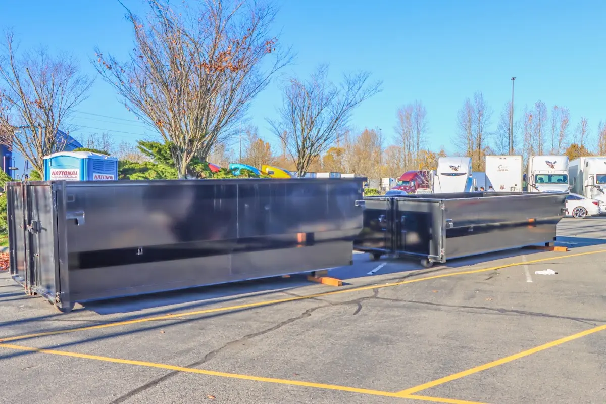 Professional dumpster rental service with roll-off container on residential driveway in Cloquet